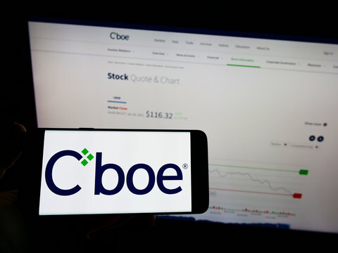 Stuttgart, Germany - 01-30-2022: Person holding mobile phone with logo of US financial company Cboe Global Markets Inc. on screen in front of web page. Focus on phone display.