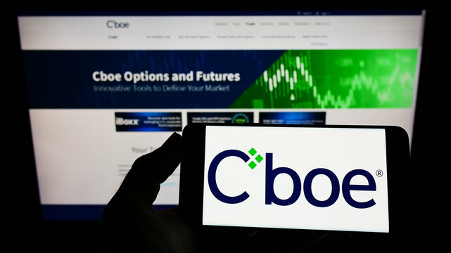 Stuttgart, Germany - 01-30-2022: Person holding smartphone with logo of US financial company Cboe Global Markets Inc. on screen in front of website. Focus on phone display.
