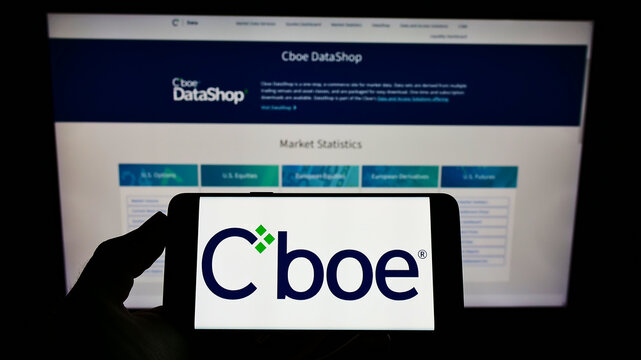 Stuttgart, Germany - 01-30-2022: Person holding cellphone with logo of American financial company Cboe Global Markets Inc. on screen in front of webpage. Focus on phone display.