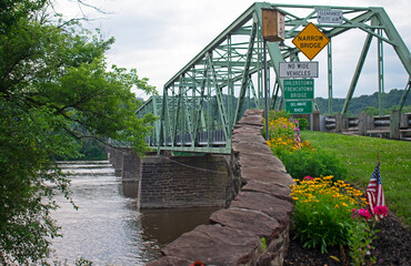 Narrow metal truss bridge crossing the Delaware River between the towns of Frenchtown, New Jersey,...