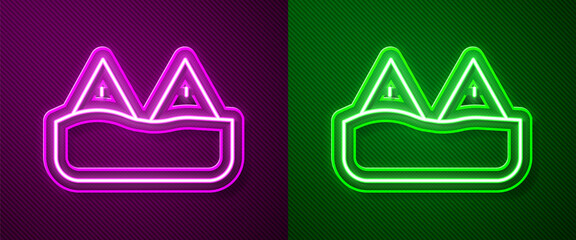 Naklejka premium Glowing neon line Whale tail in ocean wave icon isolated on purple and green background. Vector