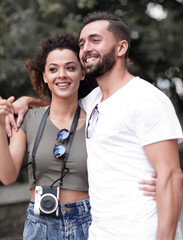 Cheerful young couple walking on urban street