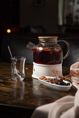 Oriental sweets and fruit tea on a wooden table with a dark background