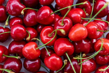 Pile of cherries on the market. Sweet cherries as background. Selective focus. 