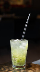 orange cocktail close up in the dark background light with free space for you text
