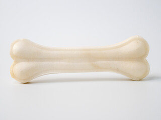 Pressed rawhide bone shaped dog chews. - obrazy, fototapety, plakaty