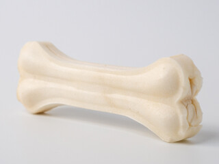 Pressed rawhide bone shaped dog chews. - obrazy, fototapety, plakaty