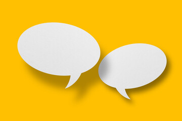 White paper in speech bubble shape set against yellow background.