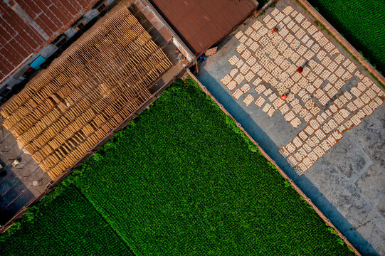 Aerial view of Women at work on the preparation of natural fabric, Barga, Rajshahi, Bangladesh.
