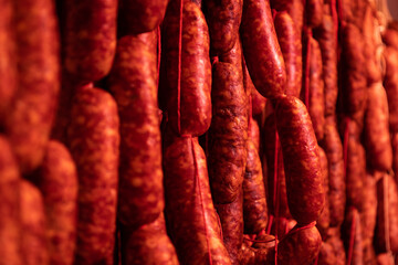 Drying red sausage. Spicy food with red paprika from the north of Spain. Selective focus.