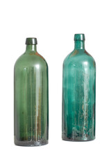 Two old empty glass bottles isolated against a white studio background with copyspace. Colourful antique glassware used as decorative art piece. Transparent vintage containers to recycle or repurpose