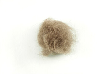 A lump of cat hair on a white isolated background