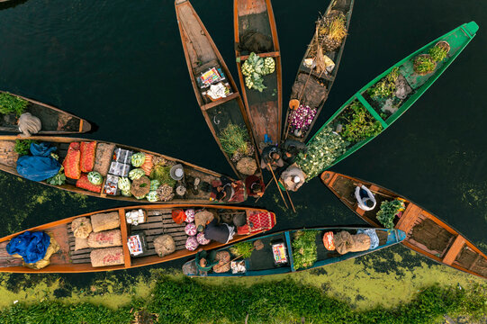 Aerial view of People on typical boats along the river during the floating market, Rainawari, Srinagar, Jammu and Kashmir, India.