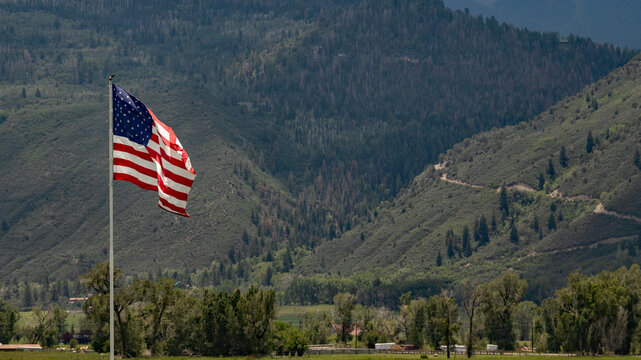 American flag majestically flying over a pasture high in the San Jaun Mountains of Colorado; concepts of American and patriotism
- Powered by Adobe
