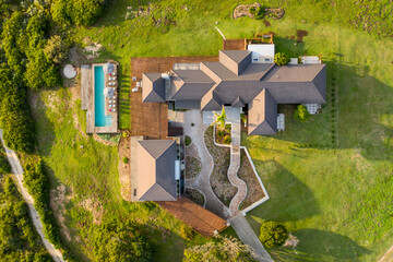 Knysa NU, South Africa - 30 March 2022: Aerial View of luxurious villa with swimming pool on the hill with beautiful sunset views, Western Cape.