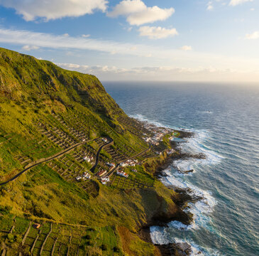 Aerial View of terrace fields on the slopes of the cliff overlooking the ocean, Santo Espirito, Azores, Portugal.