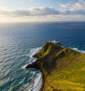 Aerial View of lighthouse on the peak of the cliff overlooking the ocean, Santo Espirito, Azores, Portugal.