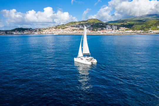 Aerial View of Sailboat while sailing in a regatta off the coast on Pico Island, Azores, Portugal.