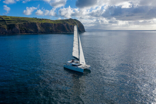 Aerial View of Sailboat while sailing in a regatta off the coast on Pico Island, Azores, Portugal.