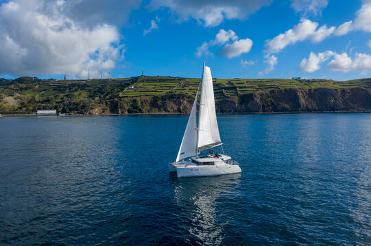 Aerial View of Sailboat while sailing in a regatta off the coast on Pico Island, Azores, Portugal.