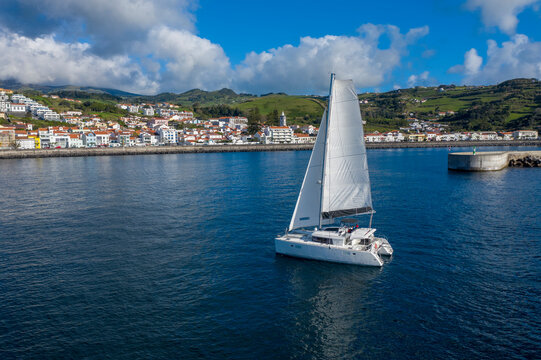 Aerial View of Sailboat while sailing in a regatta off the coast on Pico Island, Azores, Portugal.