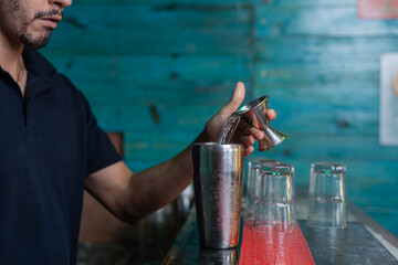 Waiter preparing a cocktail at a bar counter