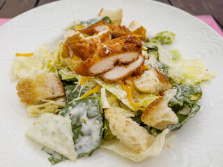 Caesar Salad with Chicken in White Dish 