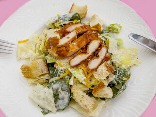 Caesar Salad with Chicken in White Dish 