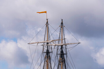 Mast tops with a flag on the replica of the old Indian Man G&ouml;theborg in a Stockholm emptied dry dock before leaving to the East India voyage a sunny summer day in Stockholm, Sweden 2022-07-05