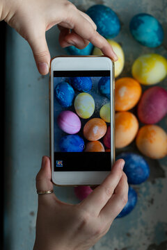 takes pictures of easter colored eggs on smartphone