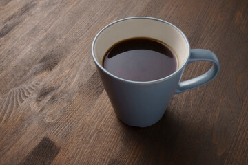 Cup of coffee close-up on a wooden table