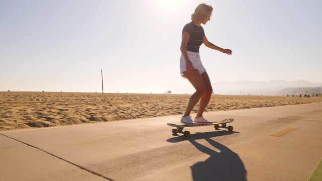 Woman Skater Doing No Comply Skateboarding Trick At Skatepark. full shot, slow motion
