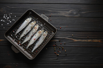 Fresh sardines on rustic background.