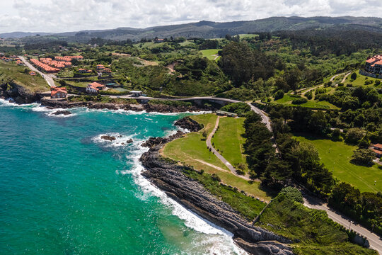 Aerial view of Playa de Portillu and the wild coastline in Comillas, Cantabria, Spain.