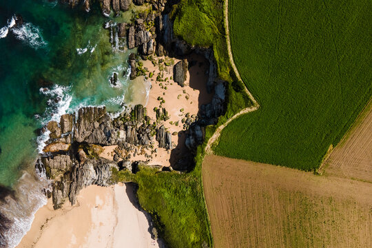 Aerial view of a small secret beach with white sand, Playa de Serantes, Tapia de Casariego, Asturias, Spain.