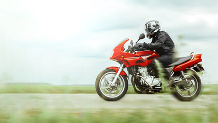 Motorcycle ride at high speed in the countryside, side view