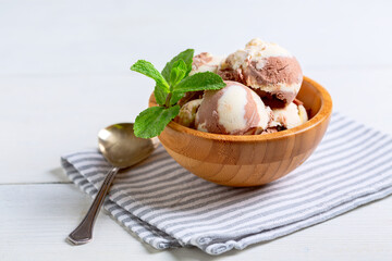 Chocolate-vanilla ice cream in a wooden bowl.