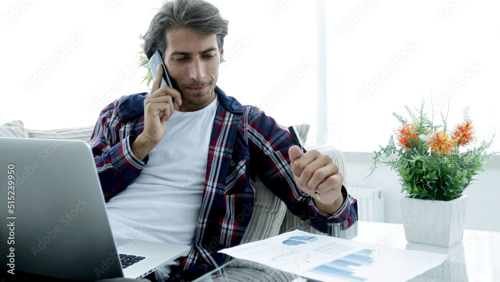 Poster modern man working with financial documents in living room