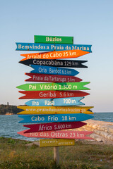 Nice and colorful sign of destinations and distances by the beach in Brazil. 