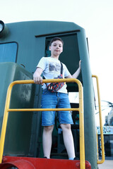 Child on Soviet Diesel shunter locomotive TGK2