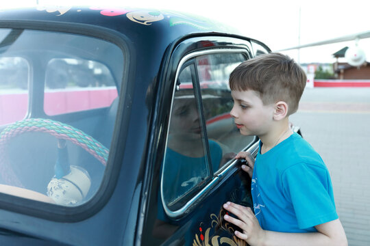 Child looking inside vintage car