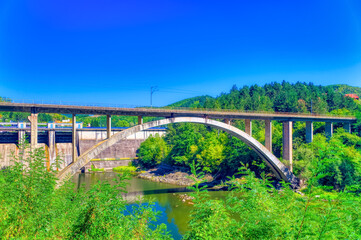Railroad bridge passing over river in Serbia.