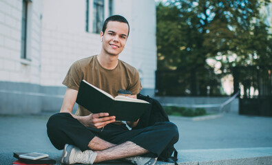 Pleasant male student in Lotus pose with copybook