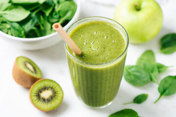 Detox green smoothie with kiwi, spinach, banana and green apple in glass