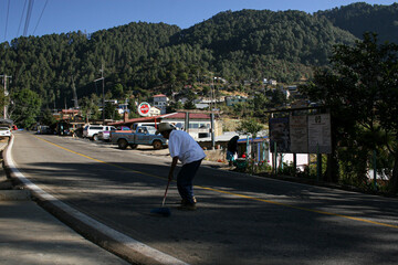 San Jose del Pacifico, Oaxaca, Mexico. February 15, 2009. A man sweeps the road in San Jose del...