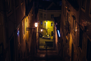 Naklejka na ściany i meble Evening view of narrow passage in Lisbon, Portugal