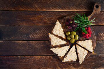 Toasts with chicken rillettes, olives and berrys. Sandwich snack with chicken pate. Top view