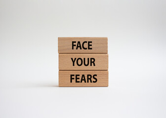 Face your Fears symbol. Wooden blocks with words Face your Fears. Beautiful white background. Business and Face your Fears. Copy space.