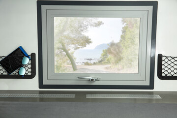 Fototapeta premium Camper window and summer trip time. Free space for your decoration. 