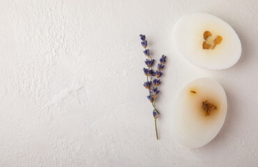 Natural lavender soap with lavender flowers on white cement background.Handmade Soap.Cosmetic product with essential oils.spa product.Space for text. Flat lay.